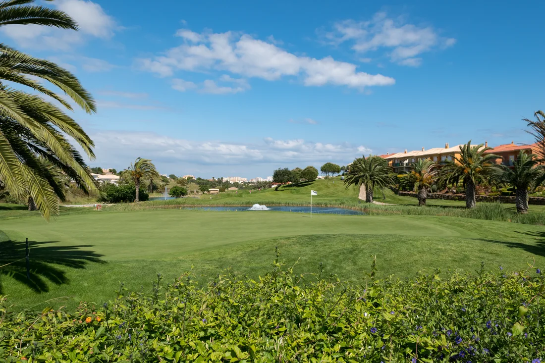 Palm-lined golf course beside a lake in Lagos, Algarve